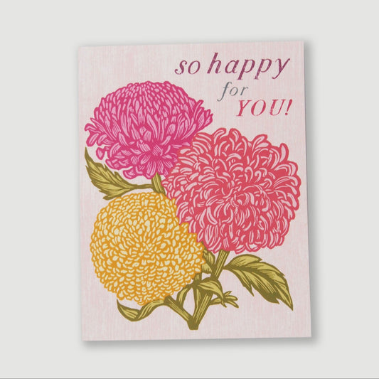 Card with pink and yellow chrysanthemum flowers and 'so happy for YOU!' text on a light pink background